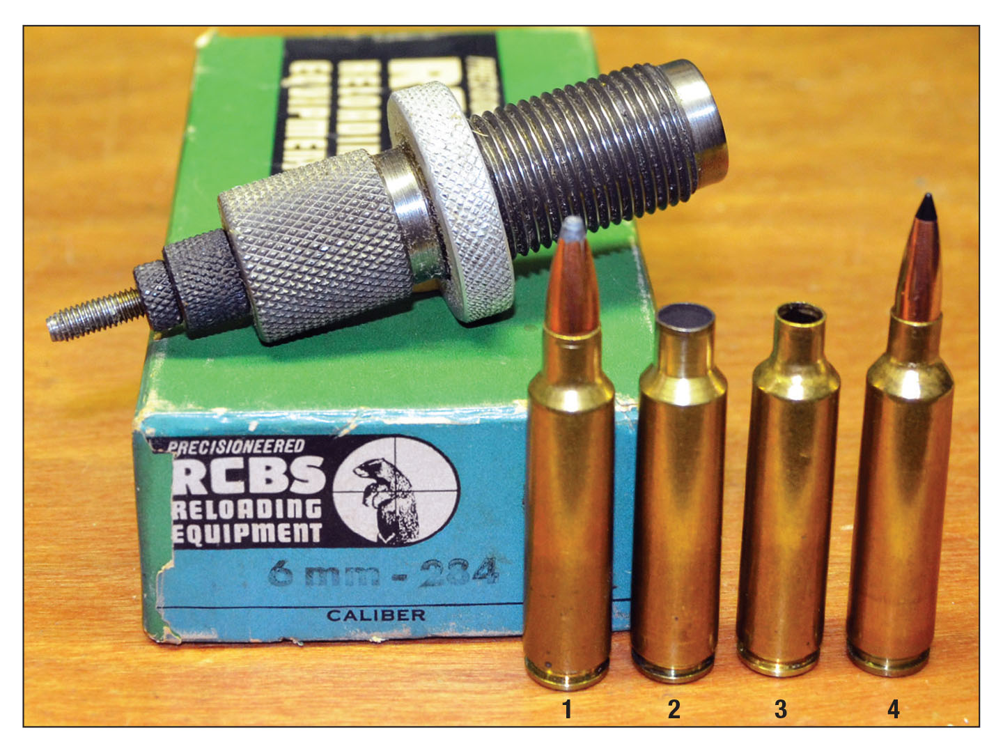 The 6mm-284 was originally formed by necking down Winchester .284 brass: (1) Winchester .284 cartridge, (2) Winchester .284 case, (3) case necked down with a 6mm-284 full-length resizing die and (4) 6mm-284 round loaded with a Swift 90-grain Scirocco II bullet.